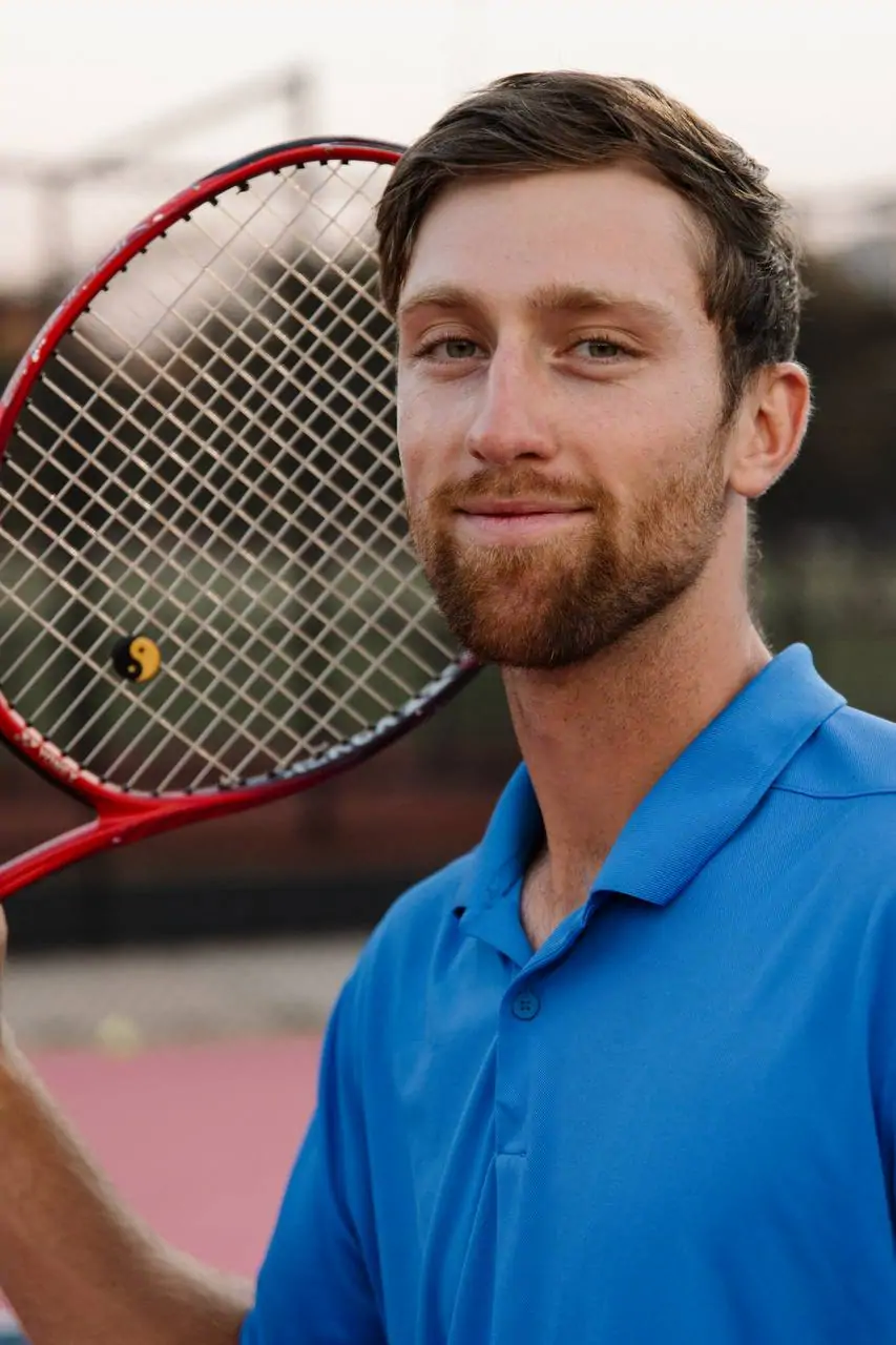 Yan holding a tennis racquet on court